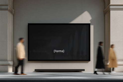 Dark blank screen mounted on gallery wall with blurred visitors walking by
