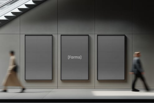 Three gallery frames on concrete wall with people walking by, center frame blank