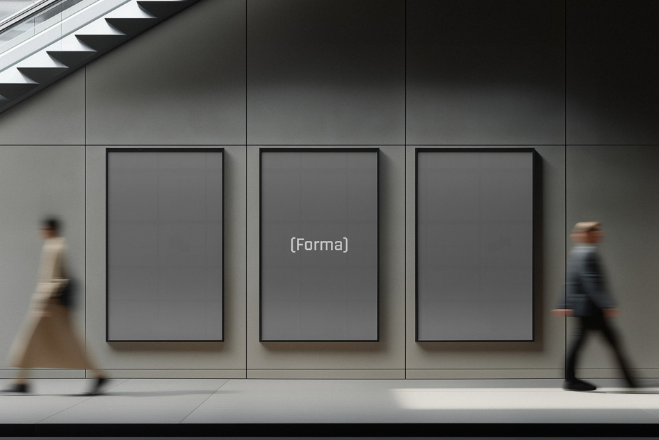 Three gallery frames on concrete wall with people walking by, center frame blank