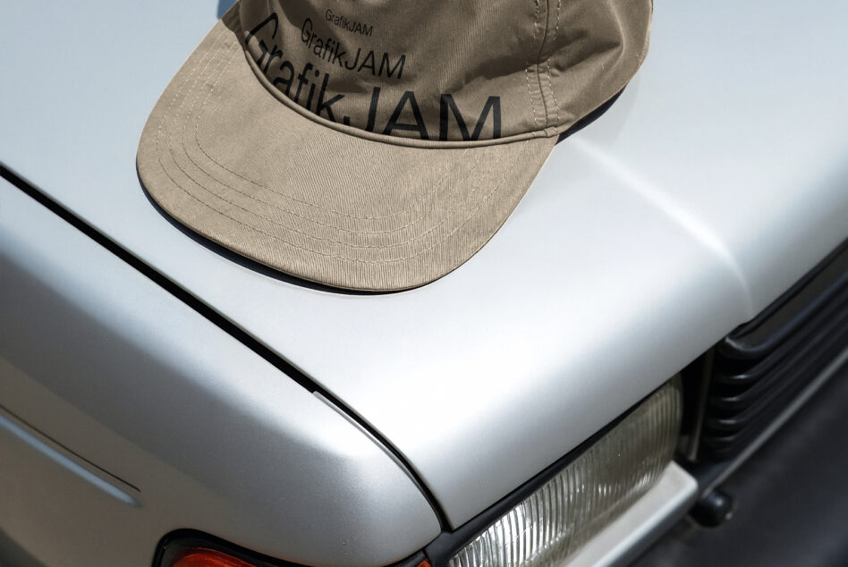 Tan baseball cap front brim close-up showing embroidered text detail