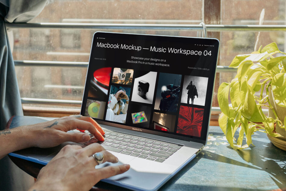 Macbook Pro displaying music workspace mockup with image grid, hands typing by window