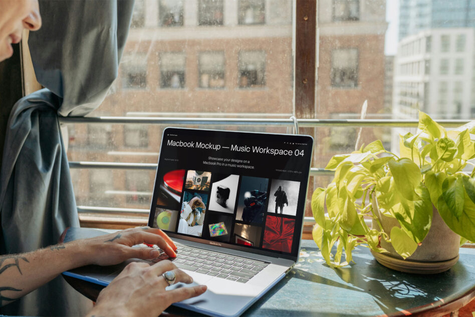 Macbook Pro open on desk displaying music workspace mockup with bright city view behind it