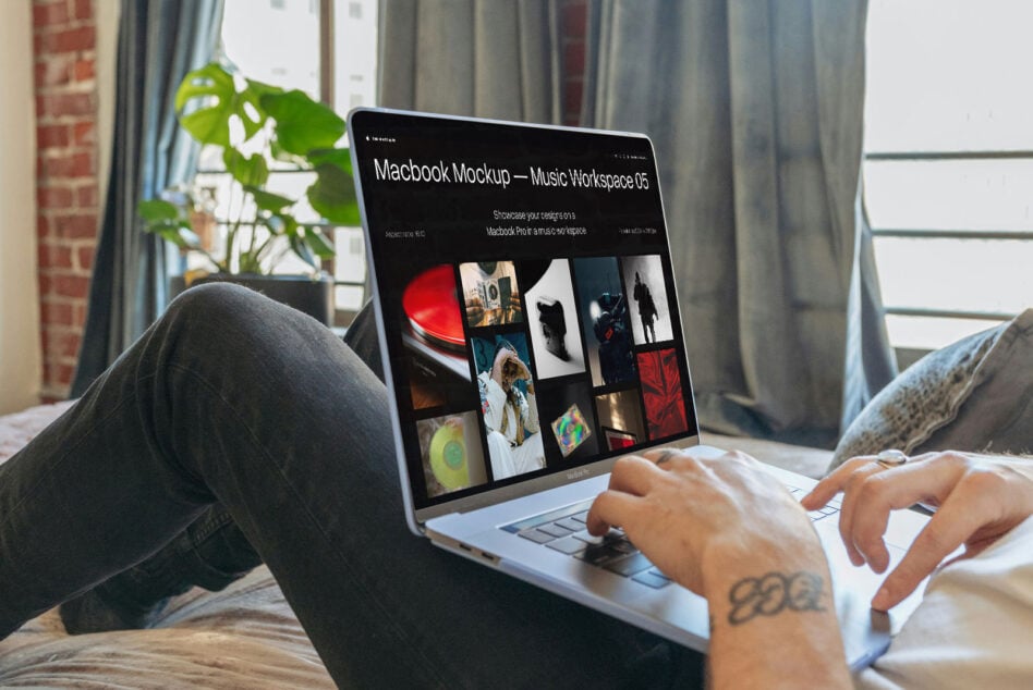 Macbook Pro screen showing dark music workspace mockup with portfolio grid layout by window