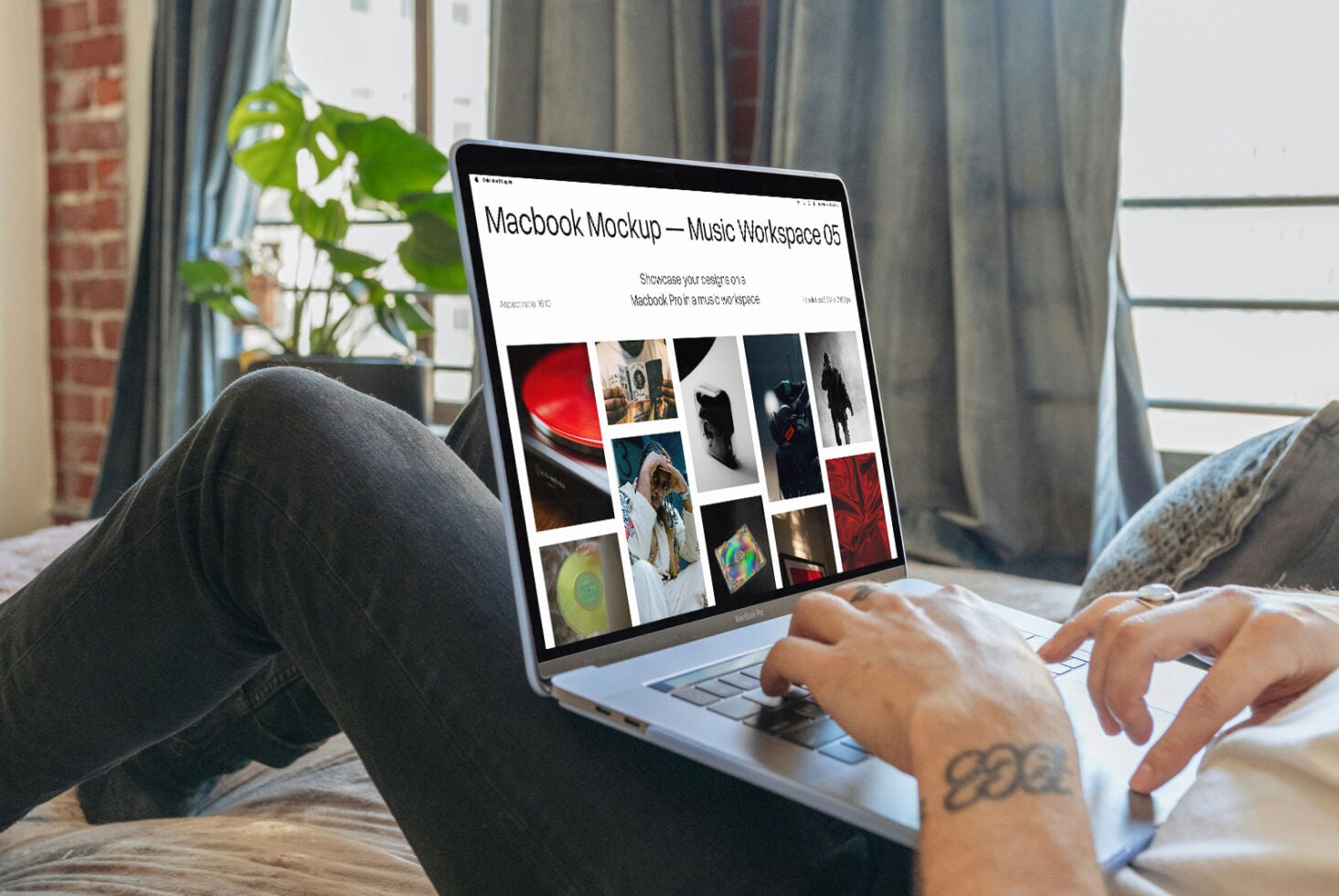 Person using Macbook Pro showing music workspace mockup with portfolio grid on bright white background