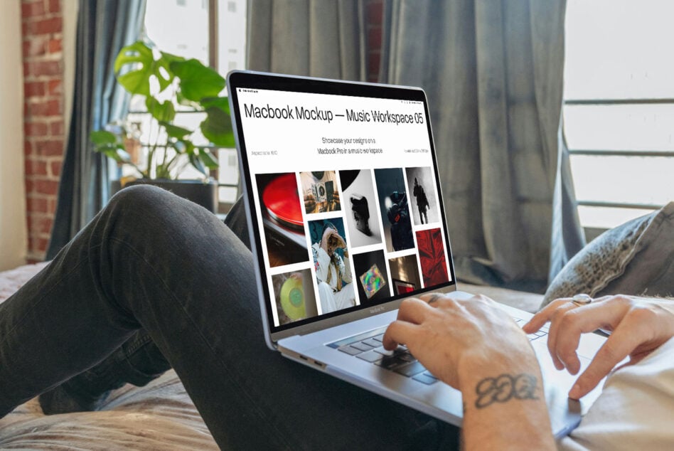 Person using Macbook Pro showing music workspace mockup with portfolio grid on bright white background