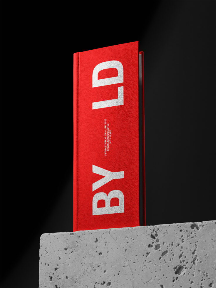 Bright red hardcover book on concrete surface showing white letters BYL design