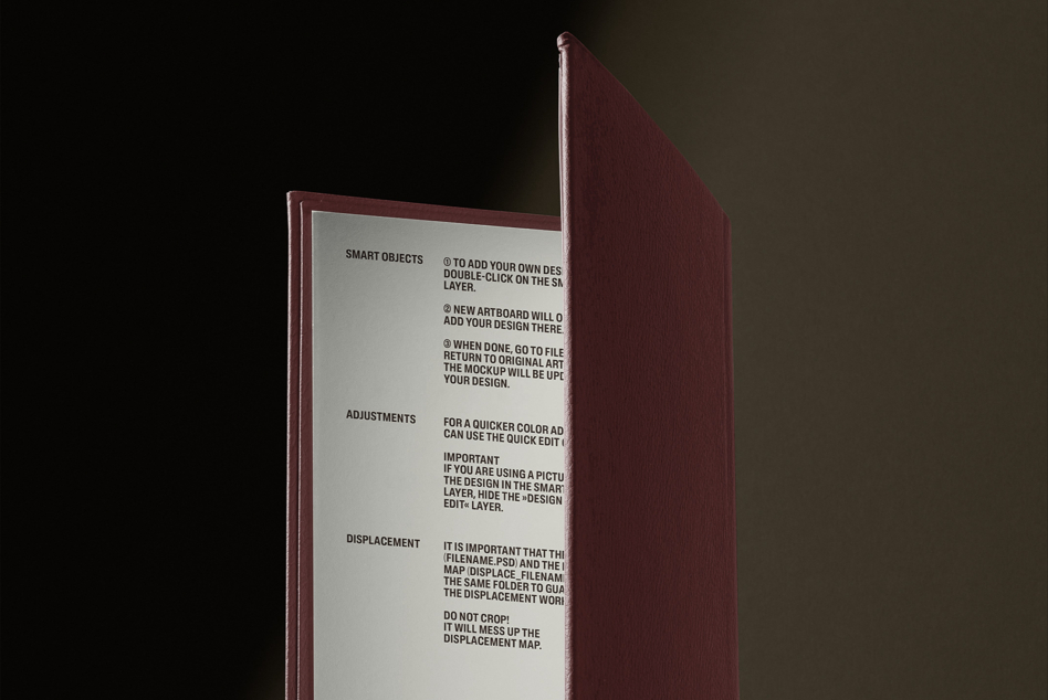 Deep red hardcover book standing open with instruction pages visible