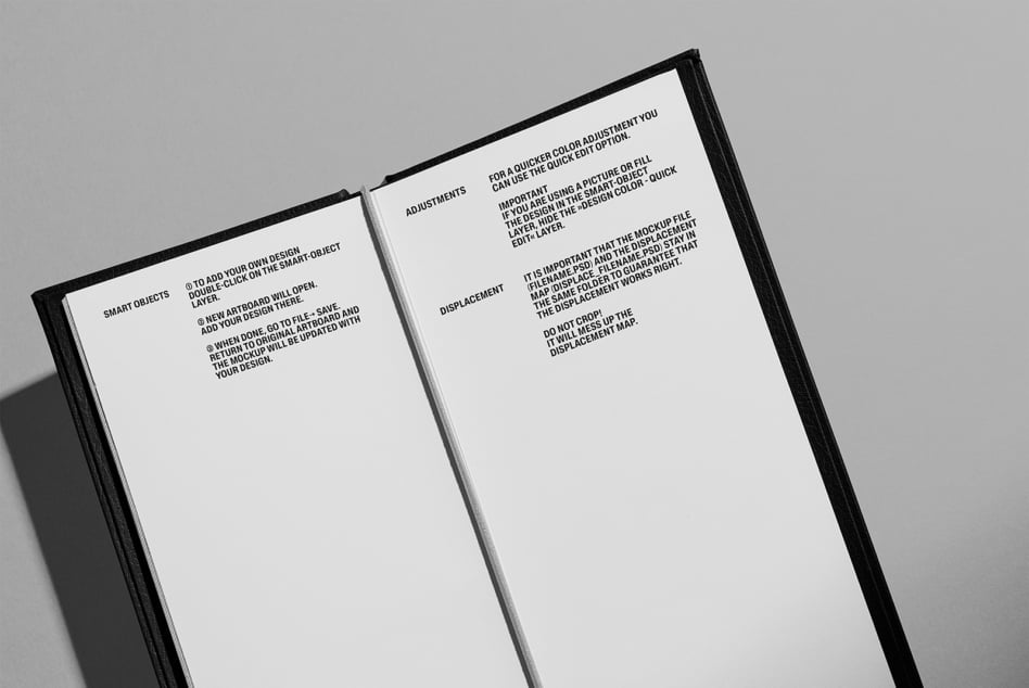 Black hardcover book opened flat showing interior pages with small text setup instructions
