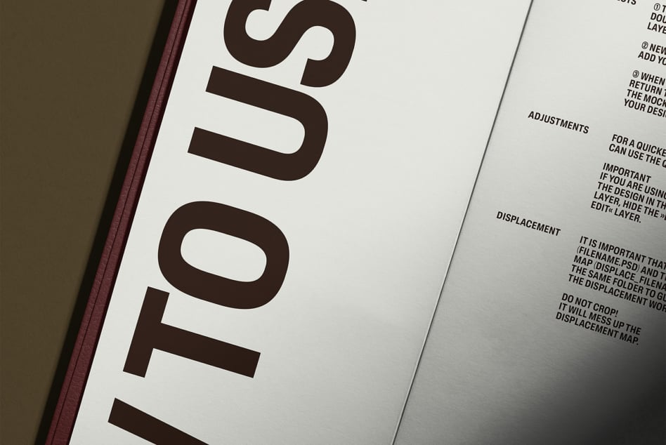 Close-up of open hardcover book with burgundy spine showing interior numbered pages
