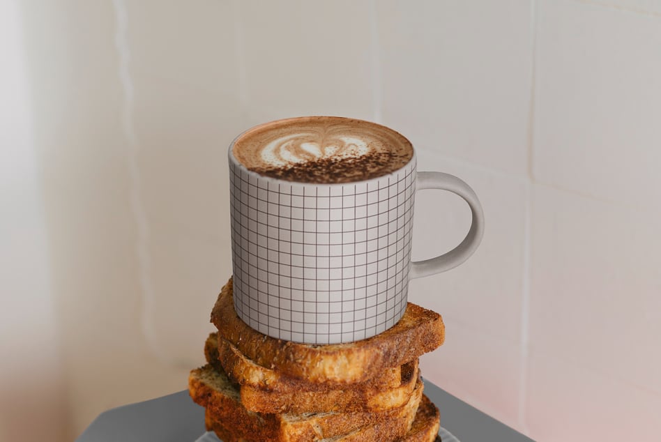 Grid pattern mug mockup filled with cappuccino on toast stack