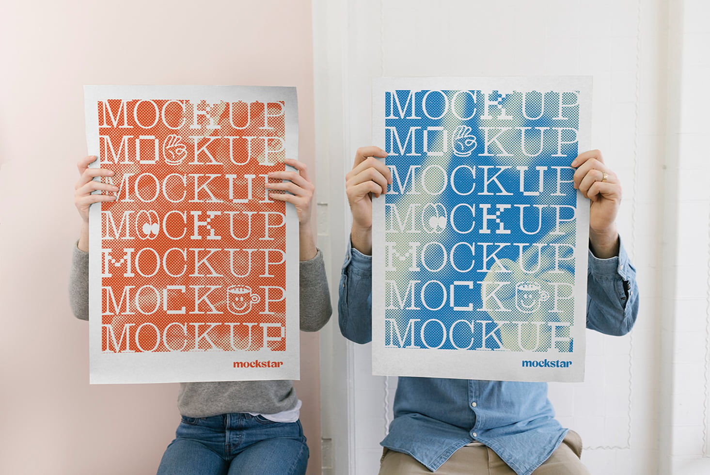Two people holding mockup posters with repeated text in orange, blue