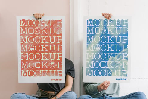 Two people holding vertical mockup posters with repeated text patterns
