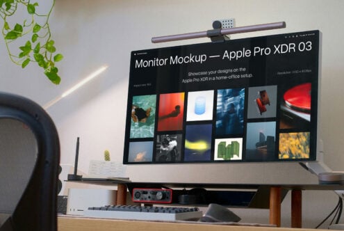 Monitor mockup showing dark interface with portfolio grid of photos