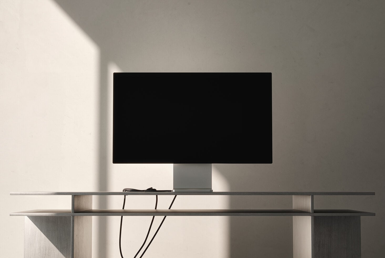 Desktop monitor on minimalist metal stand with cable management