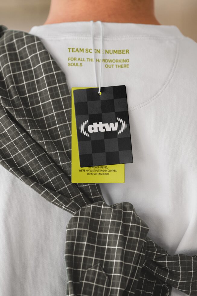 White sweatshirt with yellow-bordered hang tag mockup on body