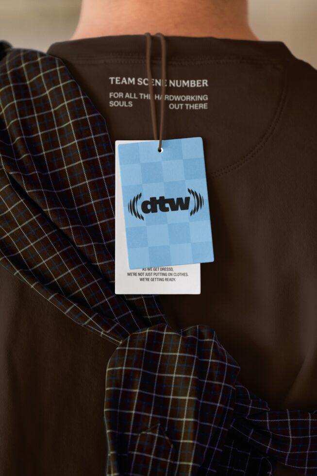 Brown sweatshirt with blue checkered hang tag mockup attached