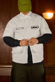 Lime cap styled with white shirt, black sleeves, featuring embroidered branding
