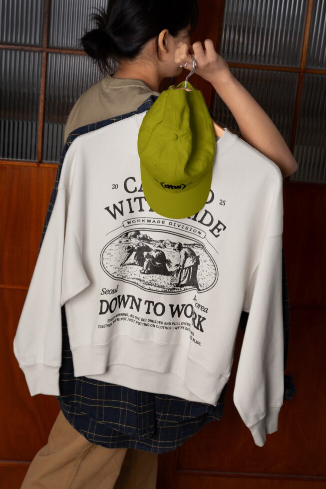 Lime green camp cap mockup hanging from sweatshirt with back print design