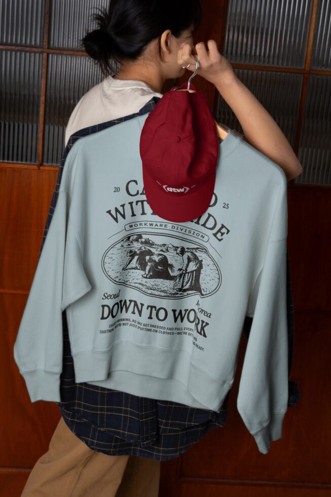 Burgundy camp cap mockup hanging from sweatshirt with back print design