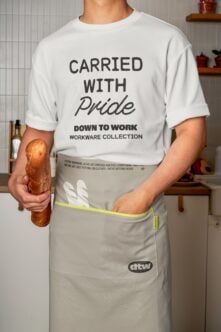 White t-shirt with Carried with Pride text mockup displaying neon yellow apron waistband trim