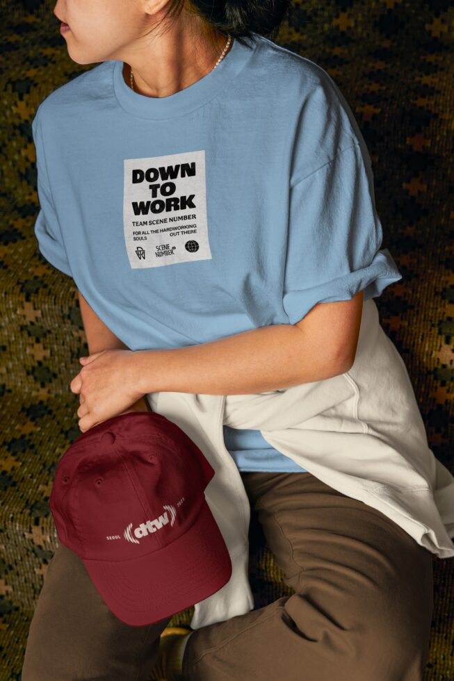 Light blue t-shirt with small Down to Work chest patch, styled with burgundy cap