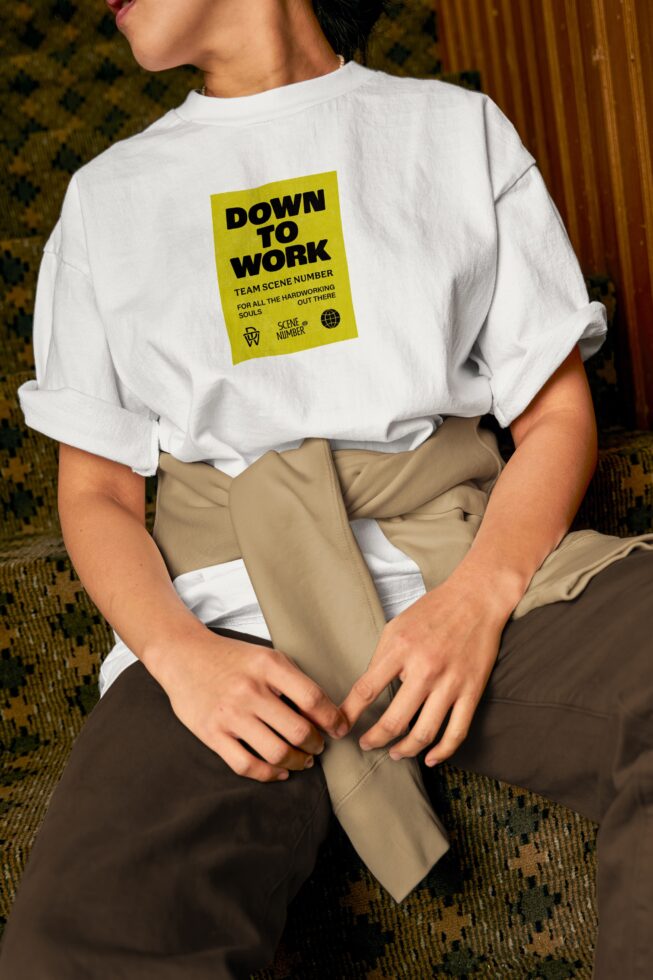 White t-shirt with yellow graphic patch on back, khaki pants