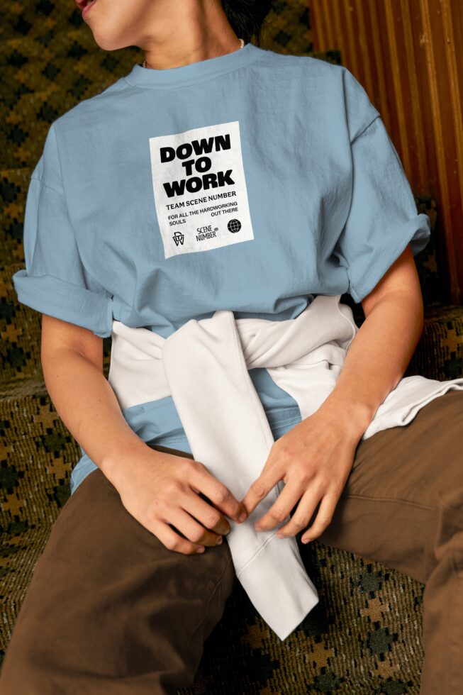 Light blue crewneck with centered Down to Work label, layered styling mockup