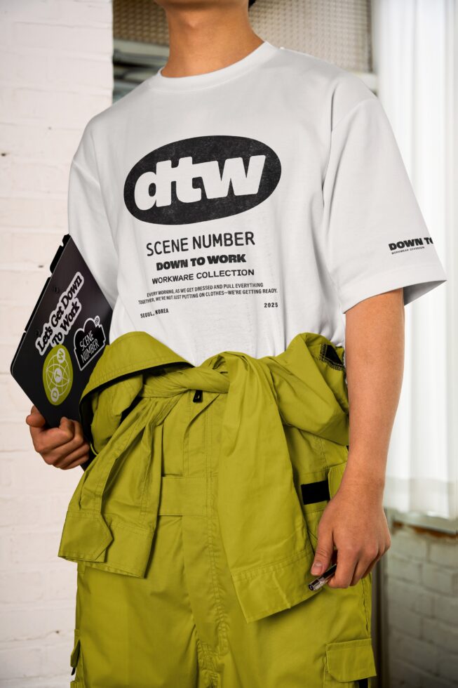 White tee with dtw badge worn with yellow green cargo pants, black clipboard