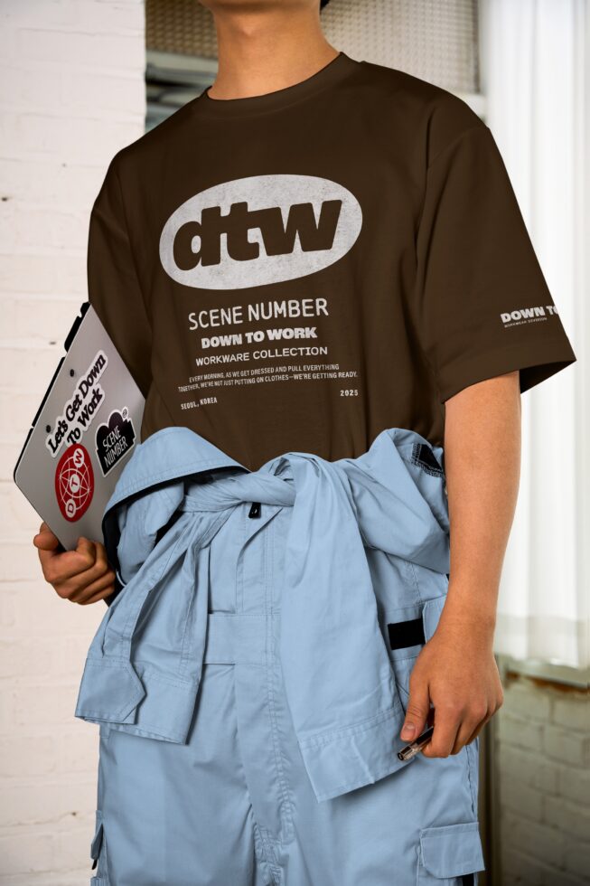 White tee with dtw logo worn over blue cargo pants, gray clipboard visible
