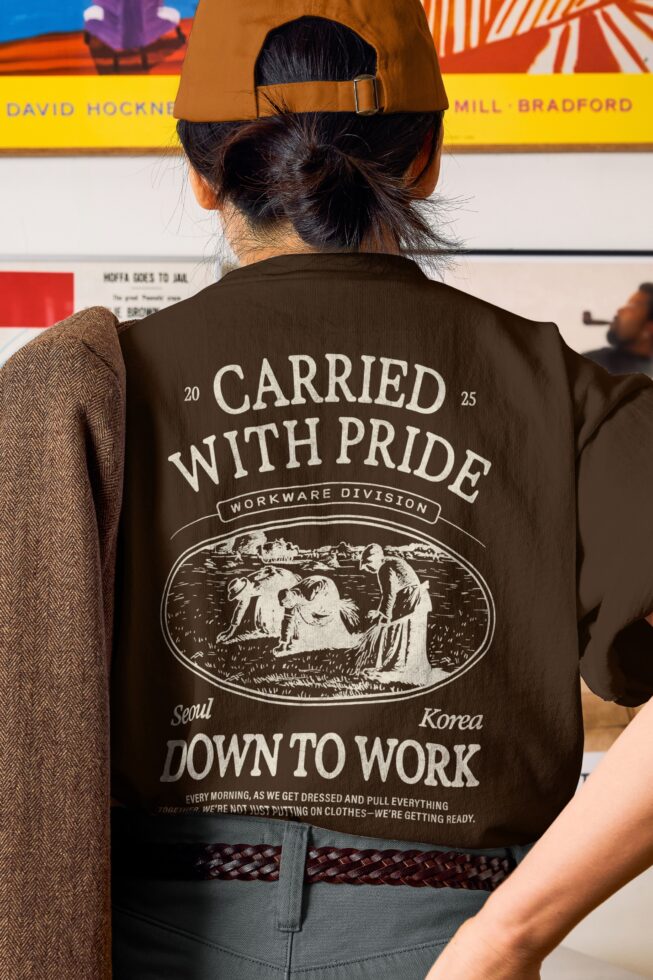 Person in brown jacket from behind displaying full Carried With Pride back print