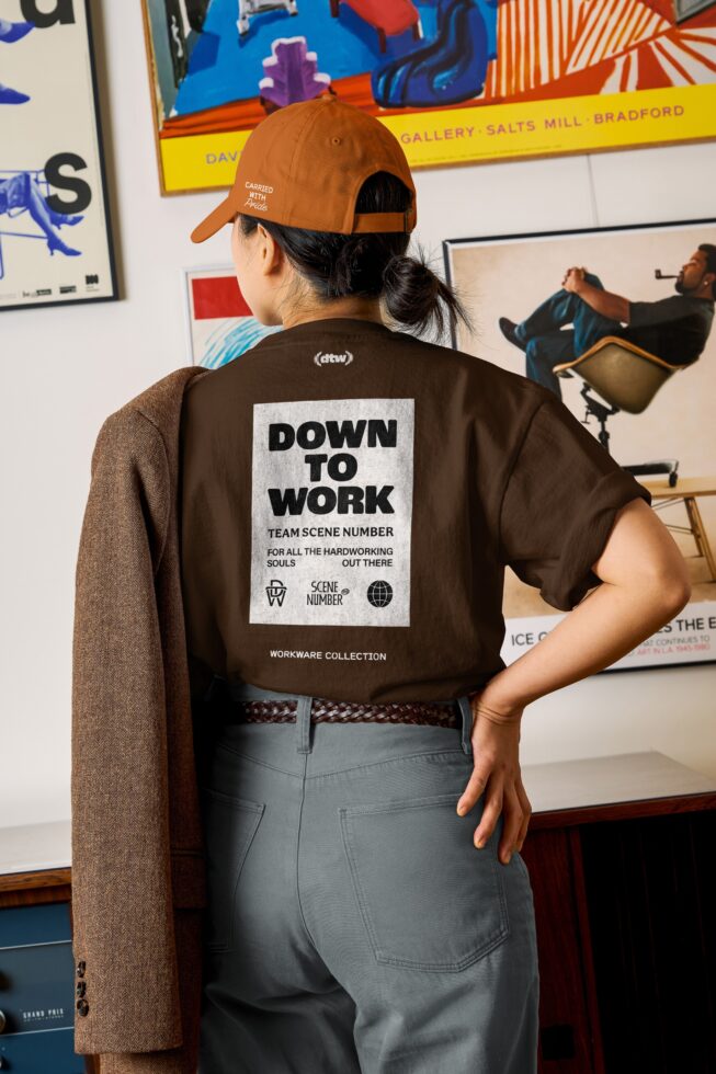 Back view showing rust cap, brown jacket with Down To Work graphic, customizable