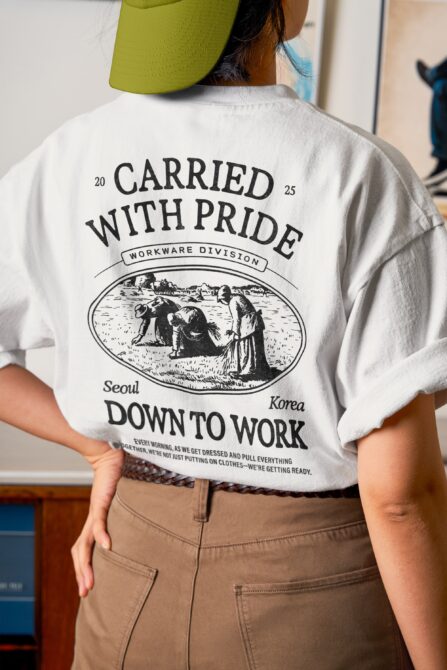 Model wearing white tee with Carried With Pride back print, lime cap visible