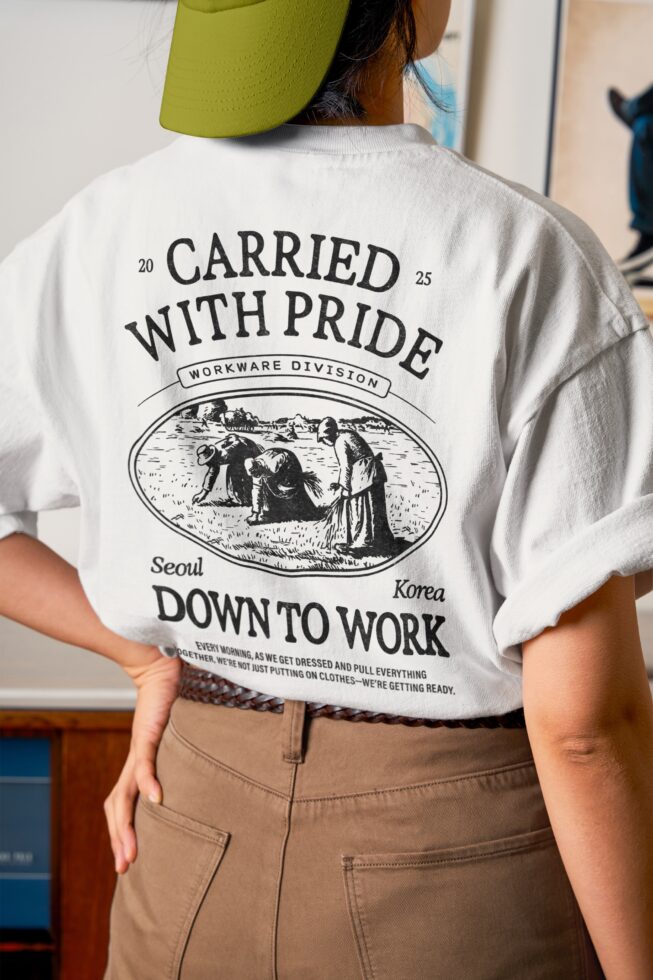 Model wearing white tee with Carried With Pride back print, lime cap visible