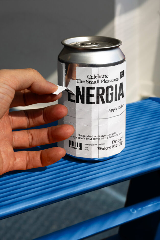 Hand gripping white aluminum can with label on blue textured shelf