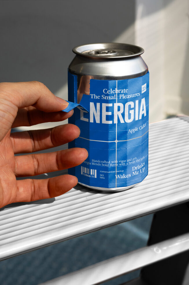 Hand holding blue ENERGIA apple cider can on white ribbed surface