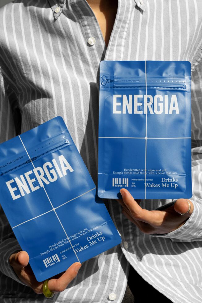 Blue coffee bag mockups with Energia branding held against striped shirt