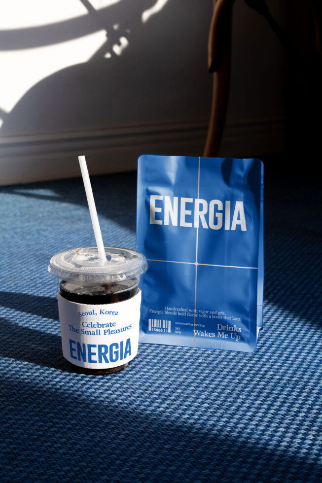Cold drink cup with white straw next to blue kraft coffee bag mockup