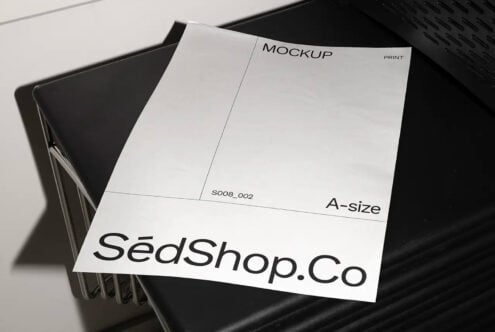 White A-size print mockup on black chair, clean minimalist studio setup