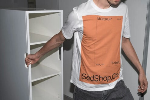 Man wearing white tee with orange print mockup holding cabinet, displaying editable label area