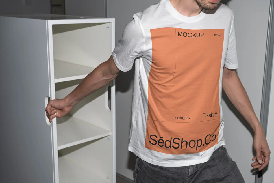 Man wearing white tee with orange print mockup holding cabinet, displaying editable label area