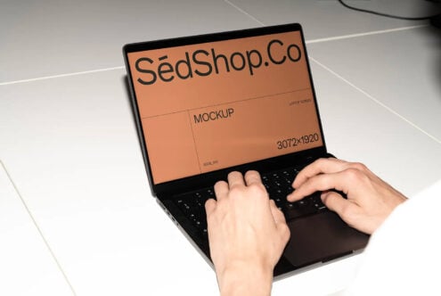 Laptop displaying orange background mockup with SedShop.Co branding