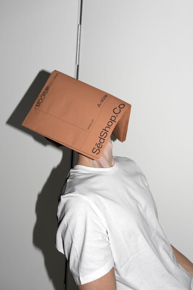 Person holding terracotta A2 mockup with SedShop.Co branding overhead