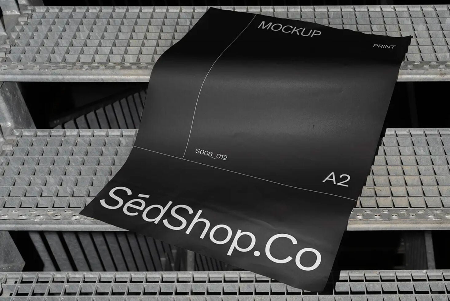 Black A2 mockup with SedShop.Co text on industrial grating backdrop