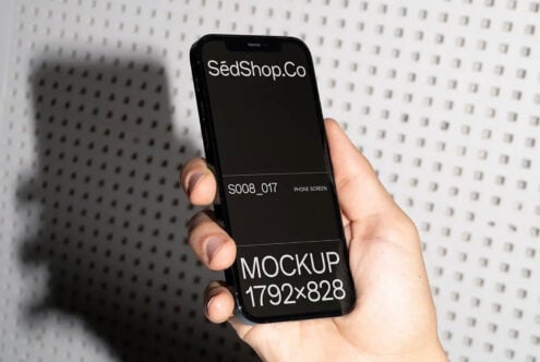 Black iPhone held in hand showing white text on dark screen mockup