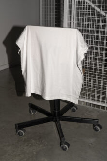 White t-shirt on black rolling stand with blank label mockup