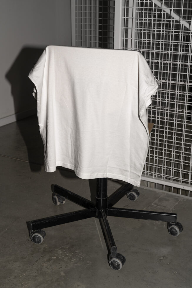 White t-shirt on black rolling stand with blank label mockup