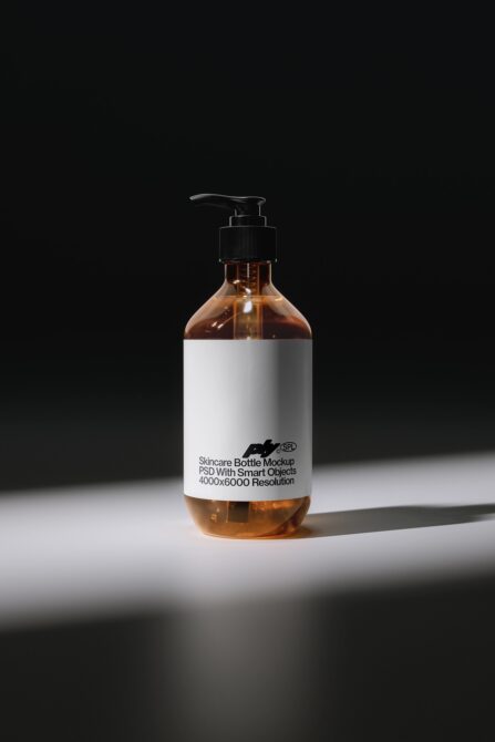 Amber glass pump bottle with white label showing skincare product mockup on dark background
