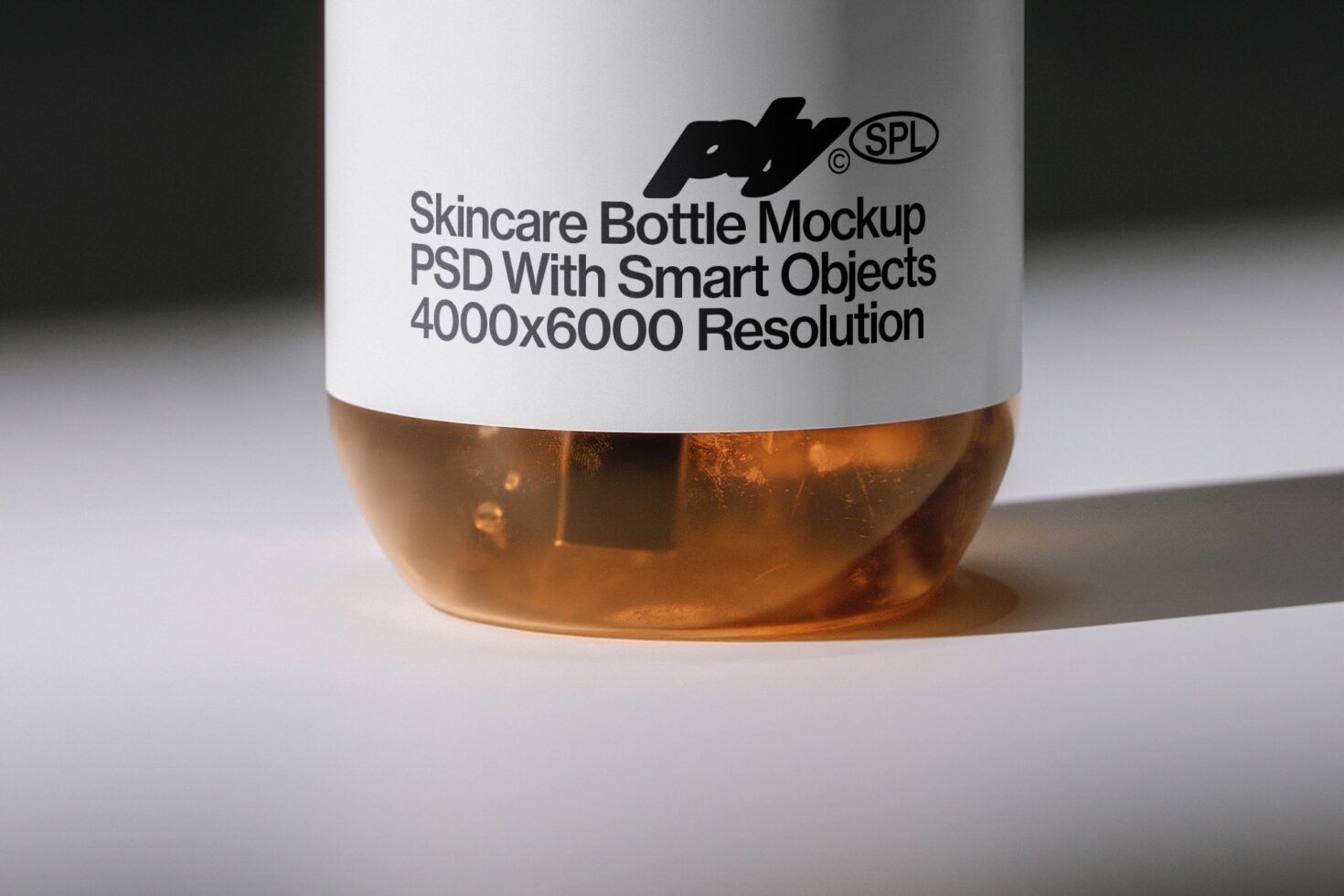 Glass skincare jar filled with golden liquid, white label with text on white surface