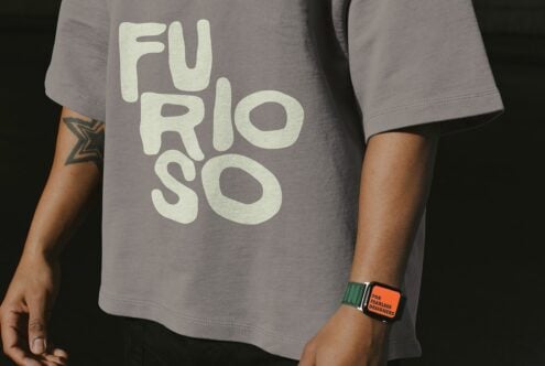 Gray tee shirt close up showing large cream text graphic on torso