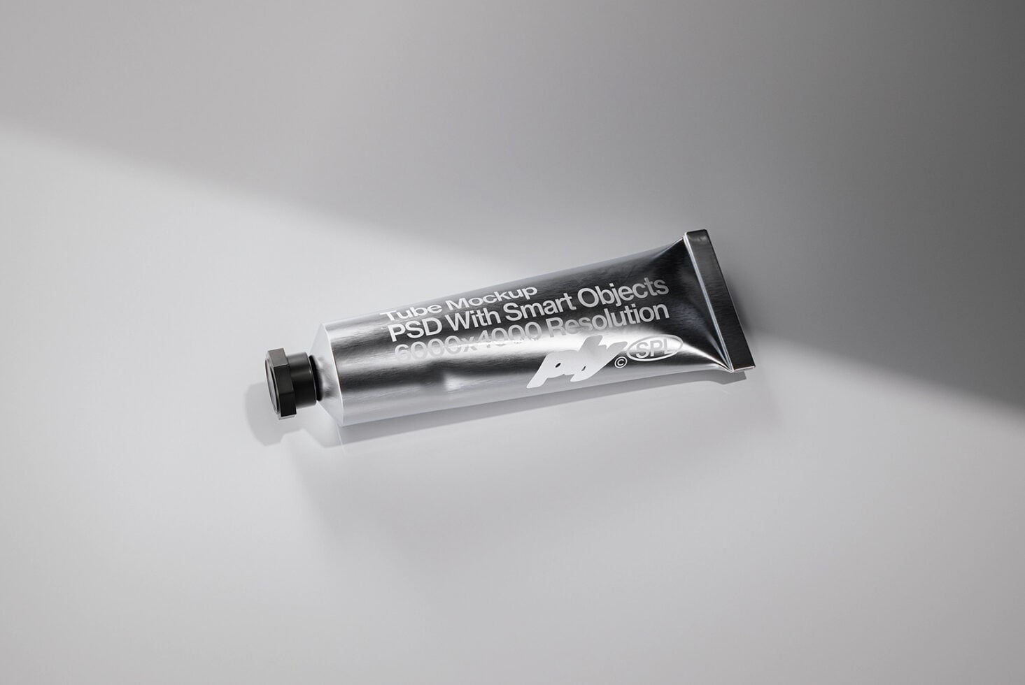 Metallic tube mockup with white label text overlay on gray backdrop